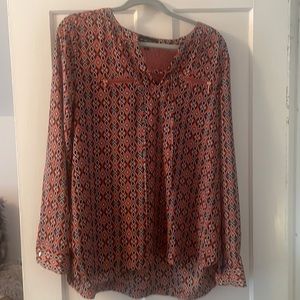 XL dressy top. Pink and black diamond design. Rose gold zippers.